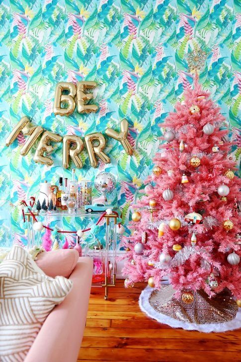 A Pink Flocked Christmas Tree with Teal Ornaments